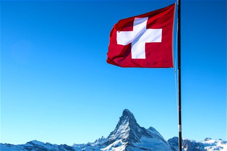 Swiss Flag Over Matterhorn Mountain Peak photo