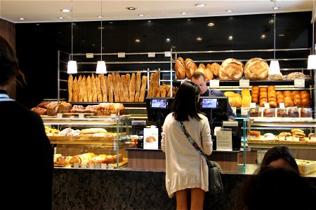 Woman Standing at Checkout in Bakery photo