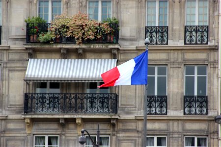 French Flag in Front of Apartment Building photo