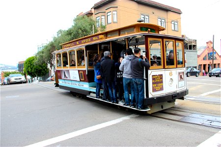 People on Cable Car on Street photo