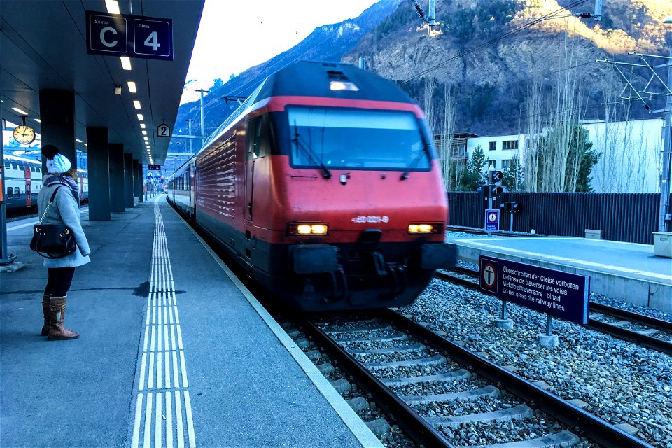 Woman Waiting as Train Approaches Station
