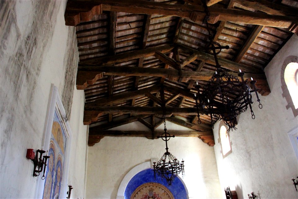 Chandeliers Hanging from Rafters of Old Church
