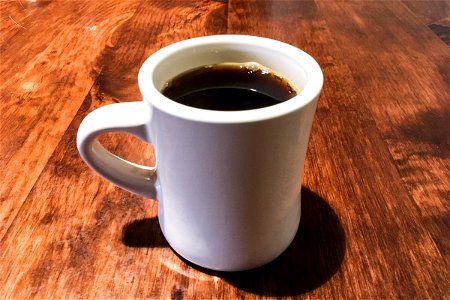 White Mug of Coffee on Wood Table