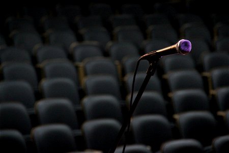 Microphone on Stand in Front of Empty Chairs photo