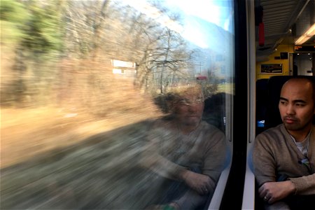 Man Staring Out Window of a Train
