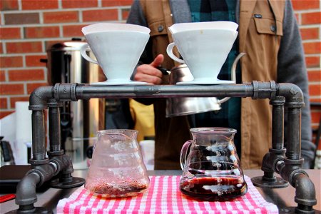 Man Standing Behind 2 Coffee Pour Overs