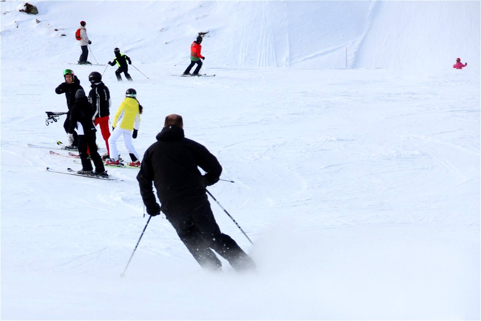 Skiers Going Down Snow photo