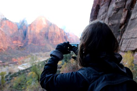 Woman Taking Picture of Mountains with Phone photo
