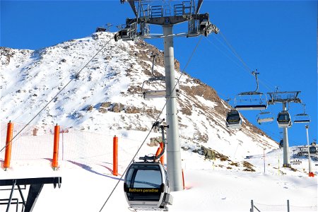 Ski Lift Gondolas on Mountain Slope photo