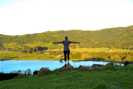 Woman on Hill with Outstretched Arms photo