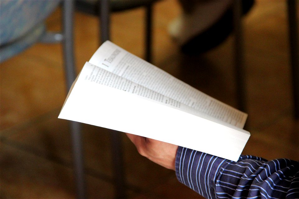 Hand Holding Open Bible