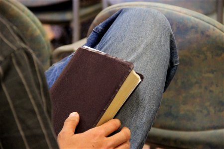 Man Sitting with Bible on His Lap photo