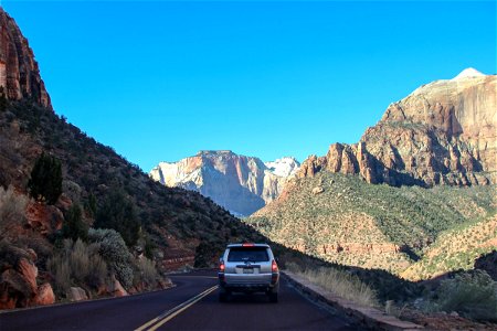 Car Driving on Road Through Mountains photo