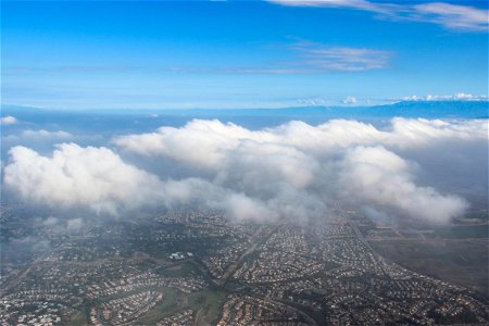 Aerial View of Clouds Above Suburbs