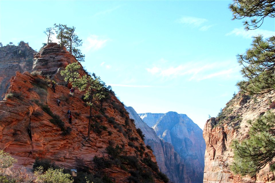People Climbing on Side of Mountain