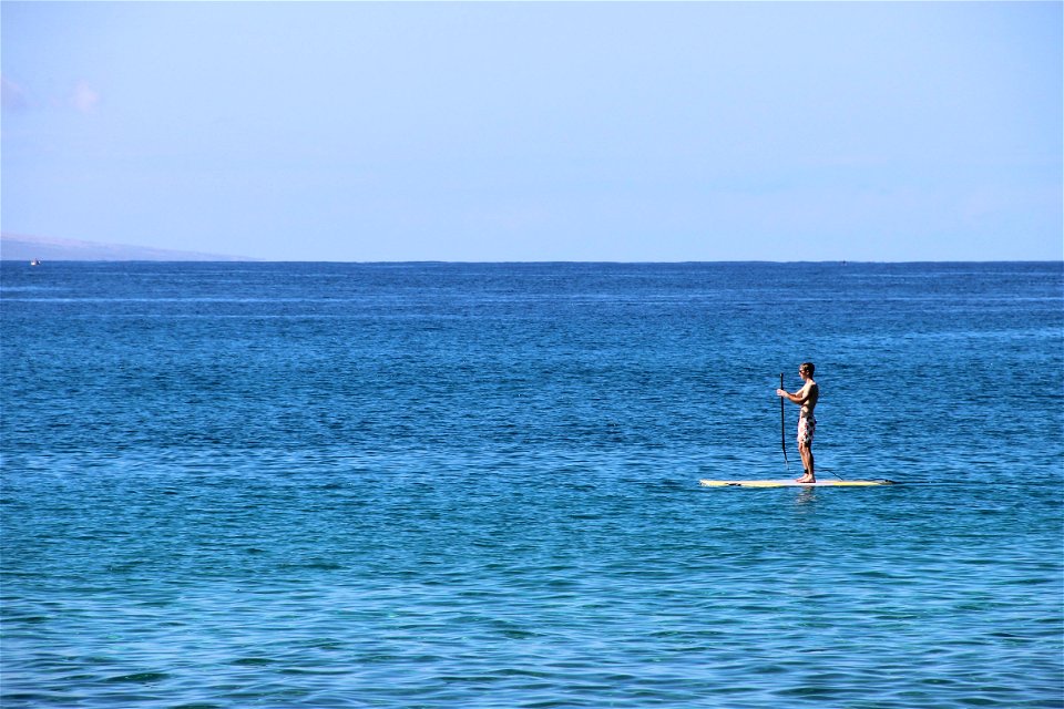 Man on Paddle Board in the Ocean photo