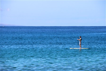 Man on Paddle Board in the Ocean photo