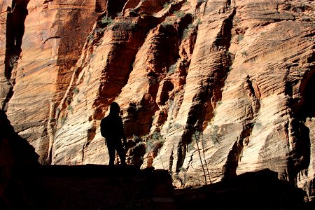 Silhouette of Woman in Front of Cliffs photo