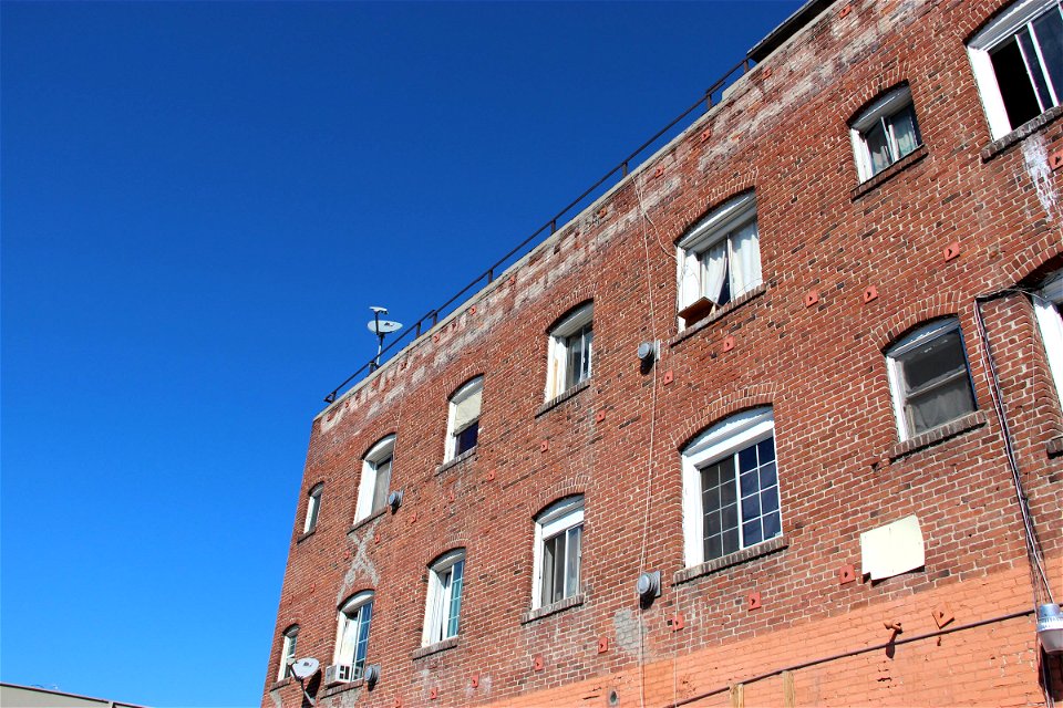 Red Brick Apartment Building on Clear Sky