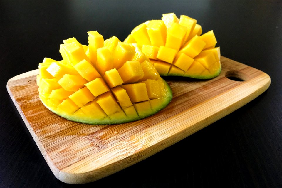Cut Up Mango on Cutting Board photo