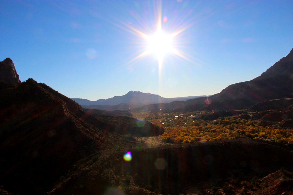 Sun Shining Over Valley & Mountains photo