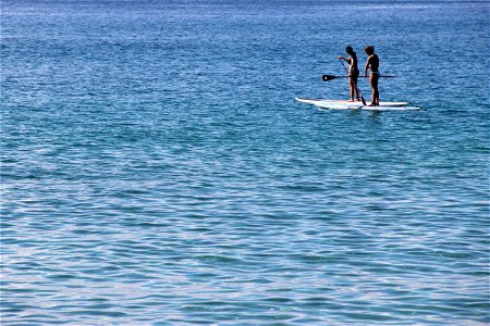 Women On Paddle Boards in Ocean photo