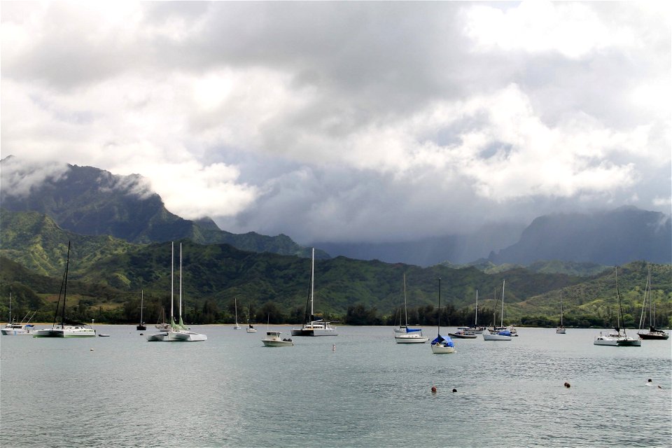 Boats in Harbor in Front of Mountains photo