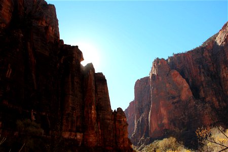 Sun Behind Cliffs in Canyon photo