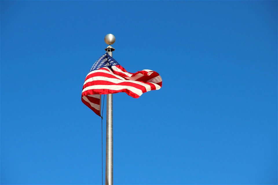 American Flag on Pole in Sky photo