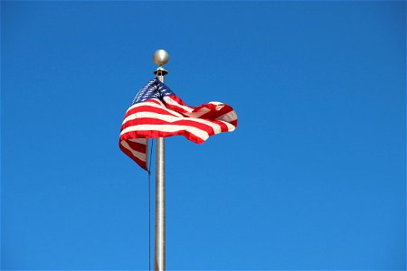 American Flag on Pole in Sky photo