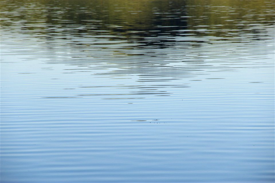 Gentle Water Ripples with Reflection of Hill