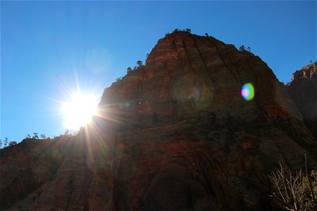 Sun Shining Next to Rock Mountain photo