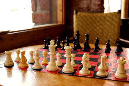 Chess Pieces on Chess Board on Table photo