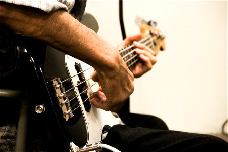Close-Up of Man Playing Bass Guitar