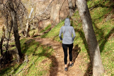 Woman in Hoodie & Yoga Pants Walking Through Nature