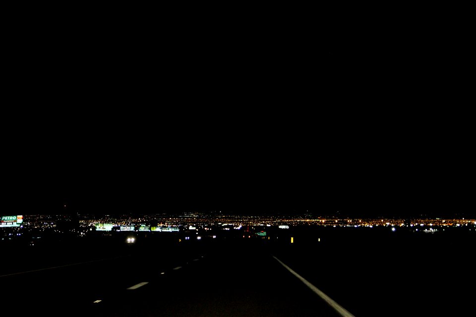 Dark Street Leading to City Lights at Night photo