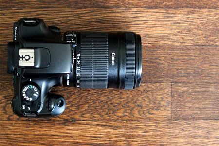 Top View of DSLR Camera on Wood Table