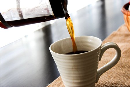 Coffee Pot Pouring into Mug photo