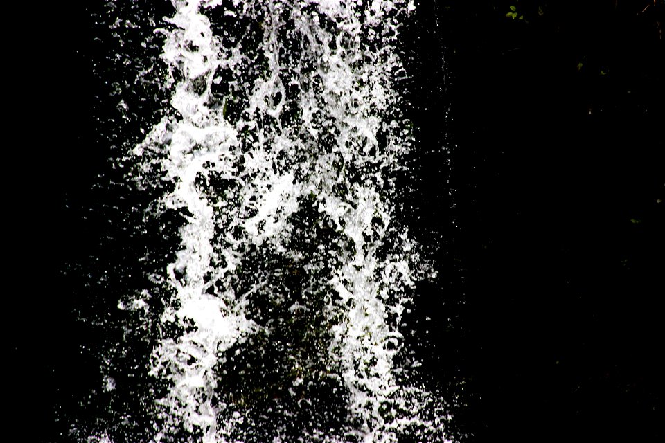 Water Falling Against Black Background