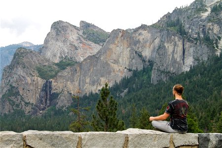 Man Meditating by Mountains photo