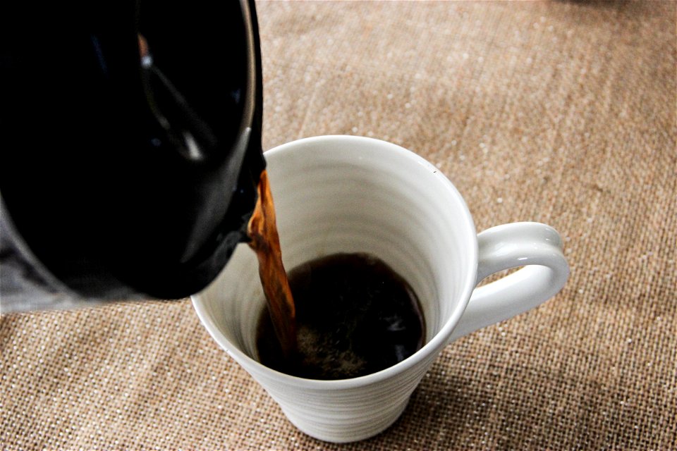 Coffee Pouring into Mug from Pot photo