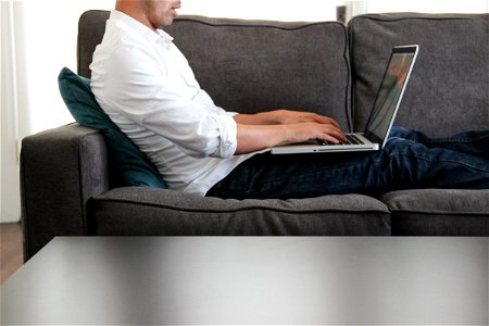 Man on Couch Working on Laptop