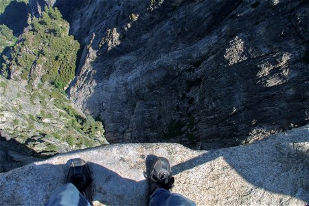 Looking Down at Feet on Edge of Cliff photo