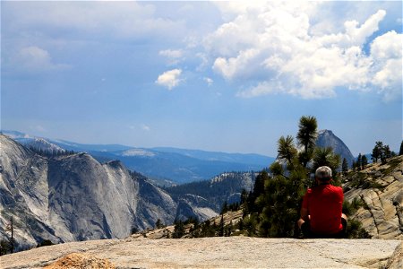 Man Sitting on Rock Looking at Scenic View photo