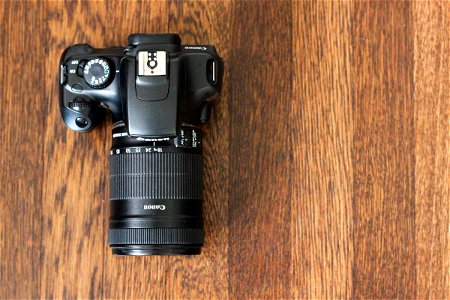 Top View of DSLR Camera on Wooden Table