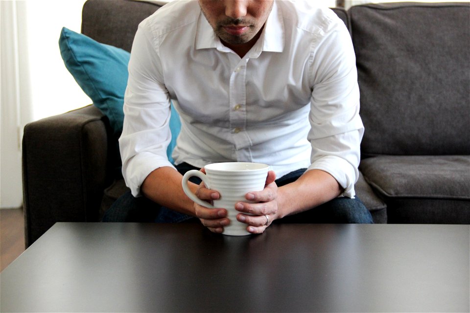 Man on Couch with Coffee Mug photo