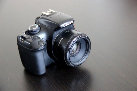Canon DSLR Camera on Dark Table photo