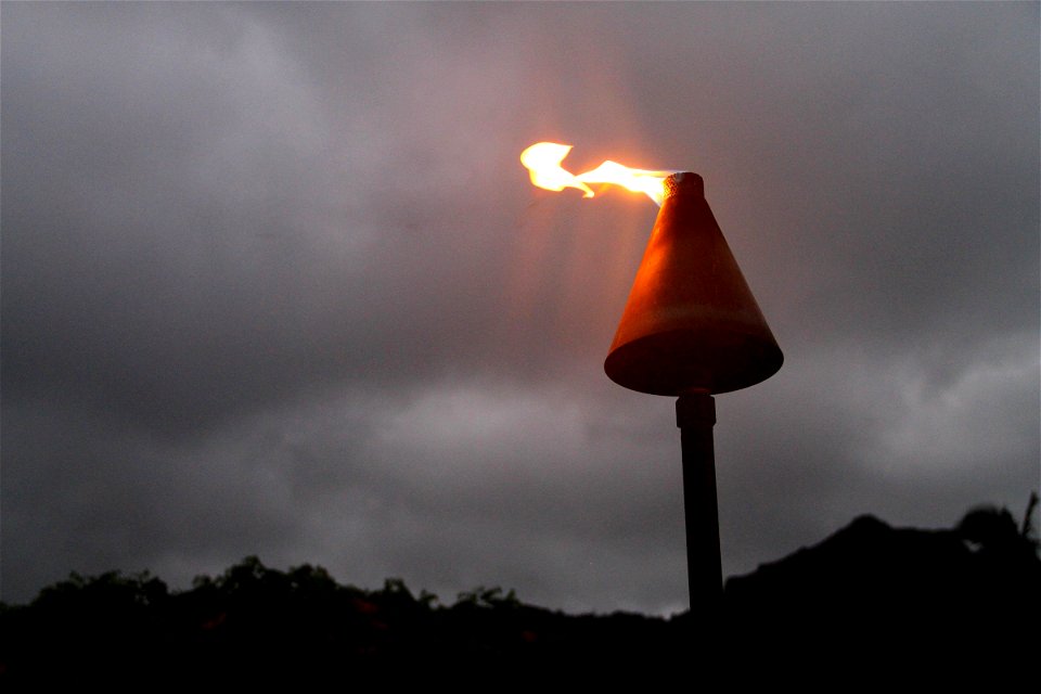 Flame on Torch in Dark Sky