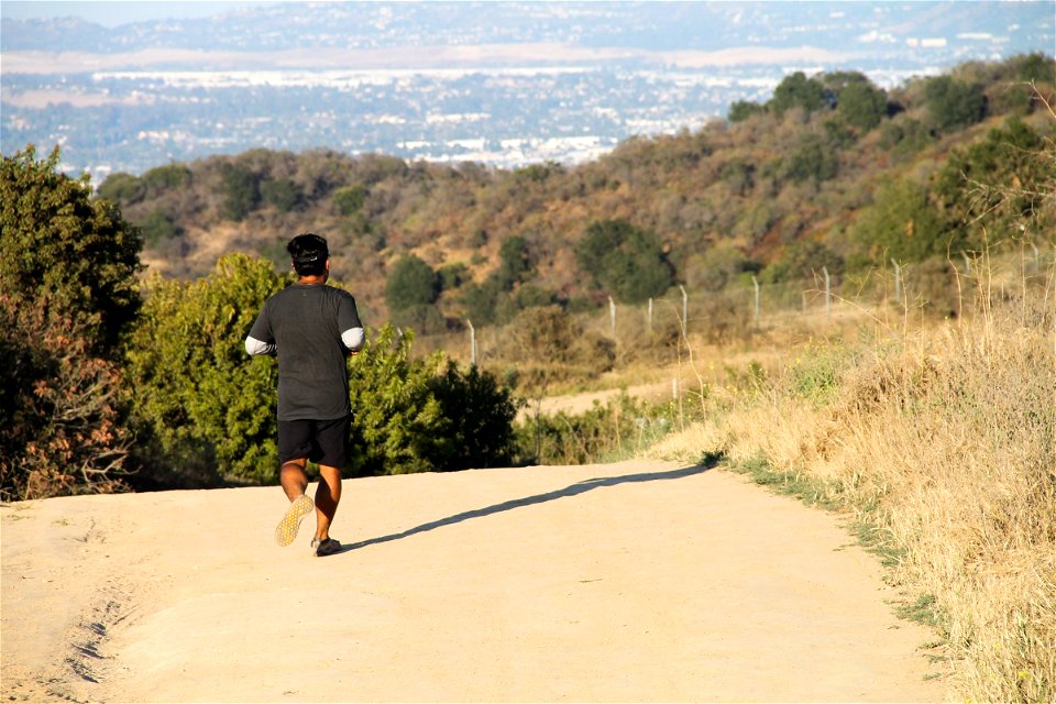 Man Running on Dry Dirt Trail
