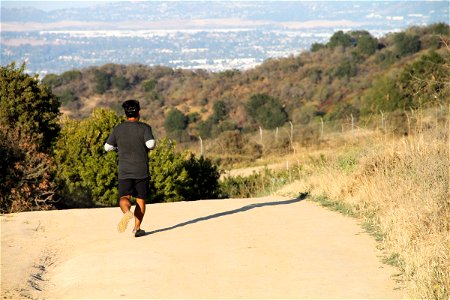 Man Running on Dry Dirt Trail photo